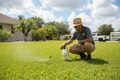 Specialist applying weed spot-treatment to Florida lawn